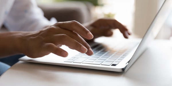 A ghostwriter typing on her computer.