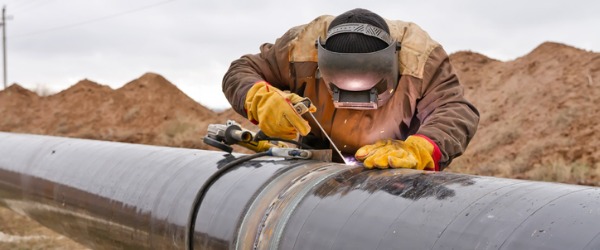 A welder working on a gas pipeline.