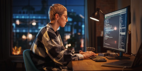 A software developer sitting at her computer.