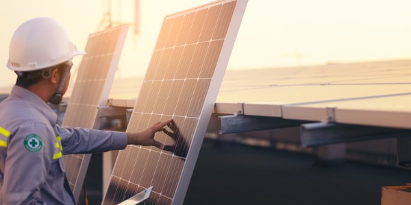 A solar engineer inspecting a solar panel.