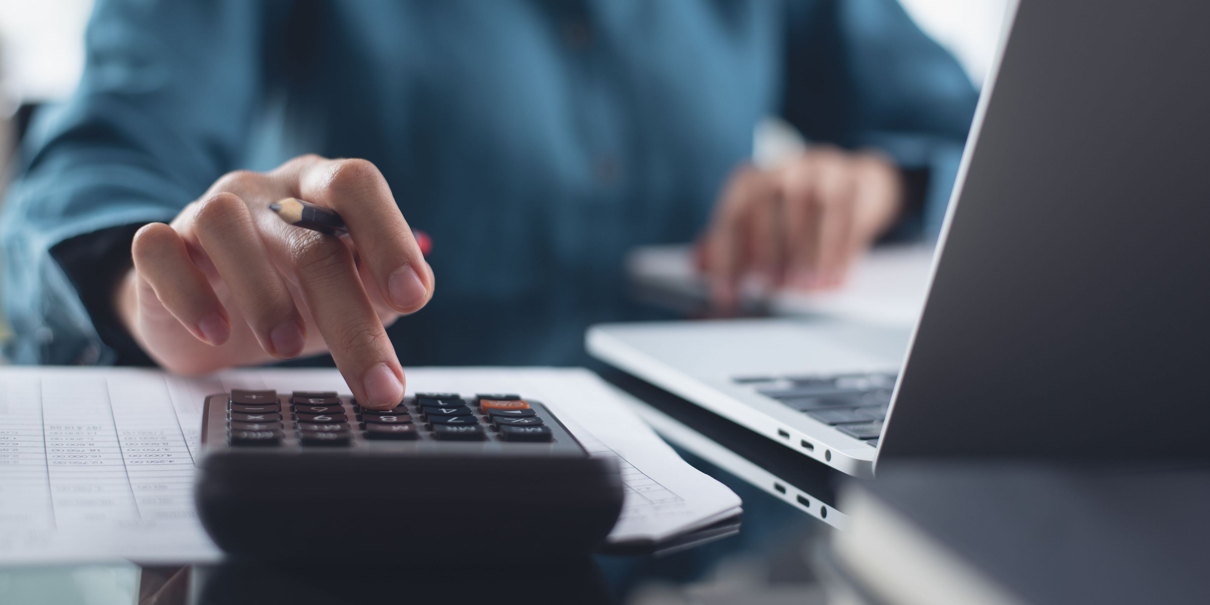 A management accountant preparing budgets and forecasts for a company.
