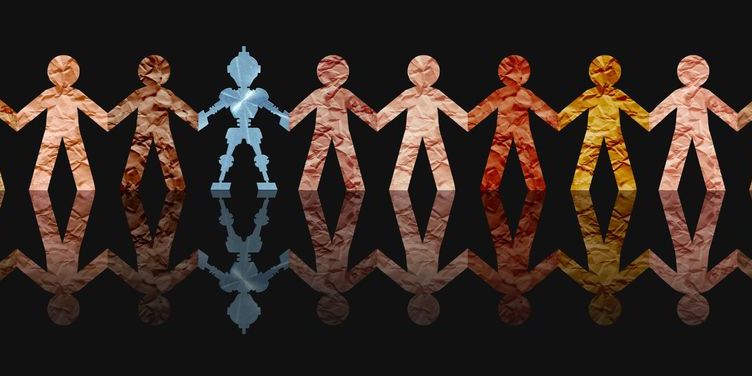 An image of paper cutouts of people holding hands along with one robot, depicting AI ethics.