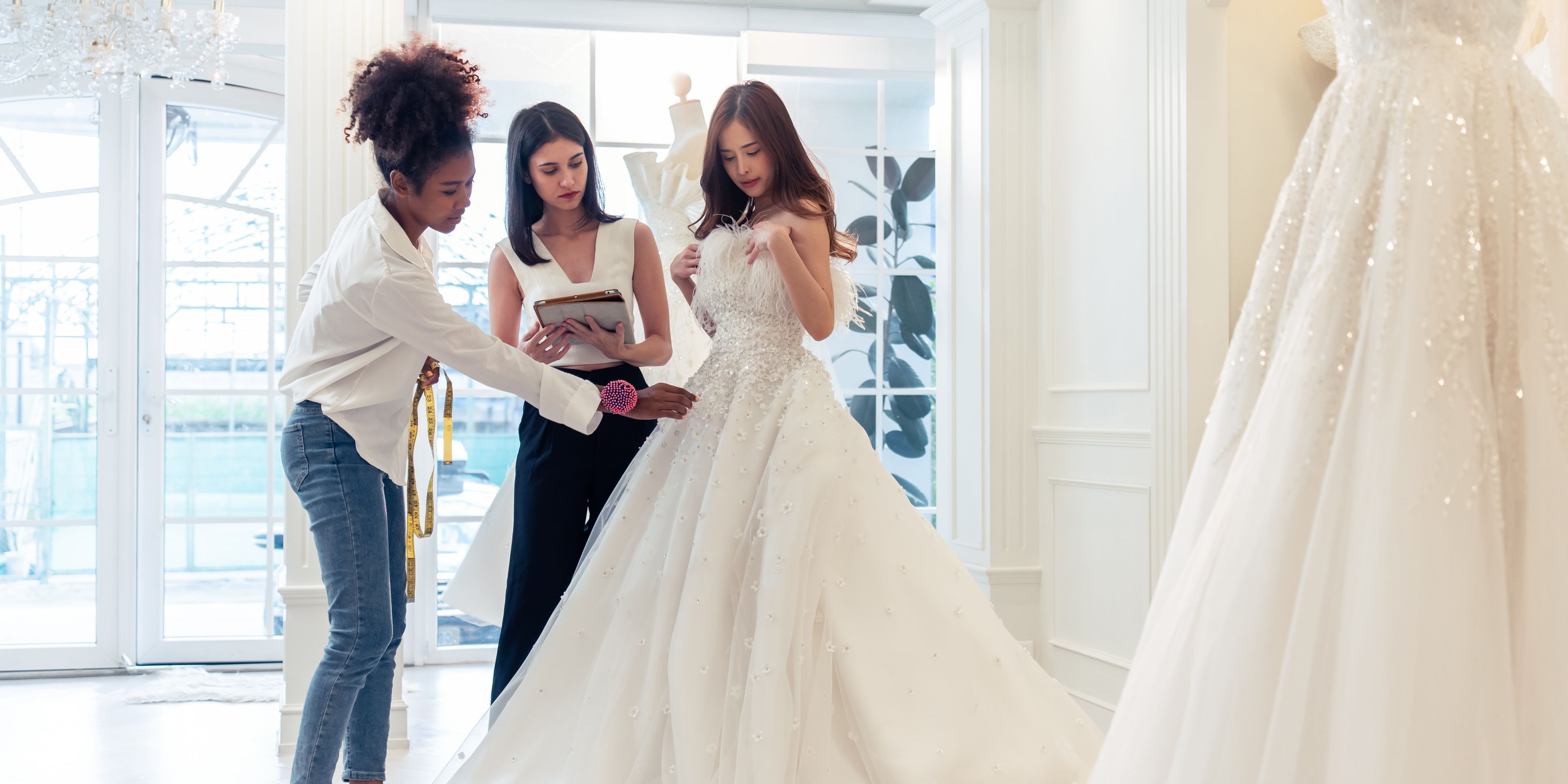 A bridal designer working with a client to create a perfect fit.