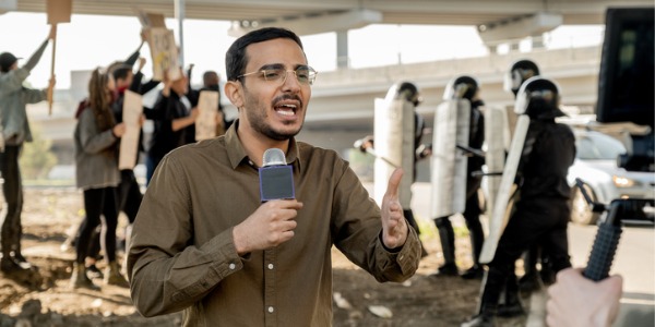 A correspondent reporting on a riot.