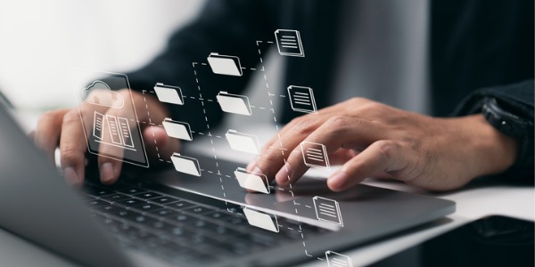 Concept of a digital archivist typing on a computer and creating digital files.