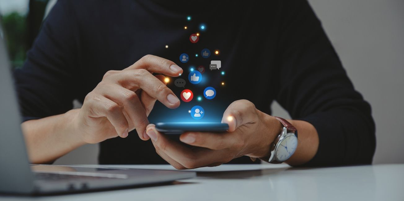 A community moderator concept of a hand using a smartphone.