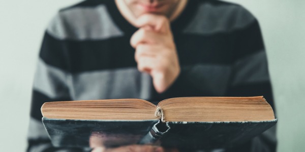 A historian reading an old book.